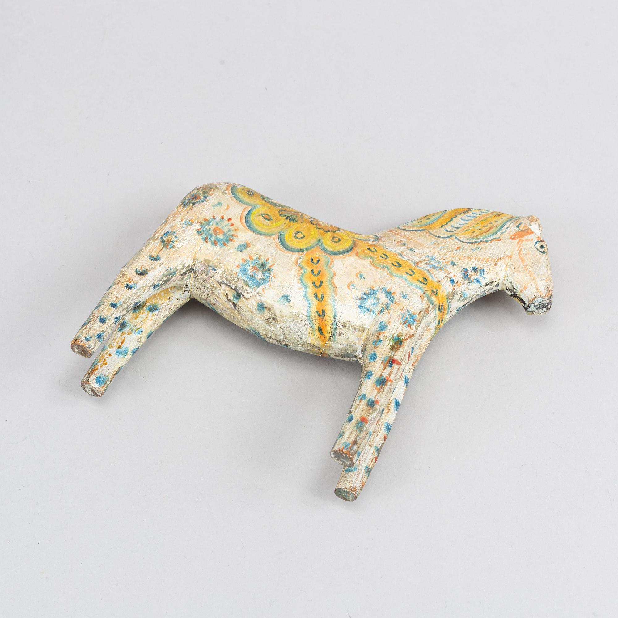 A painted Swedish wooden horse from the first half of the 20th century.