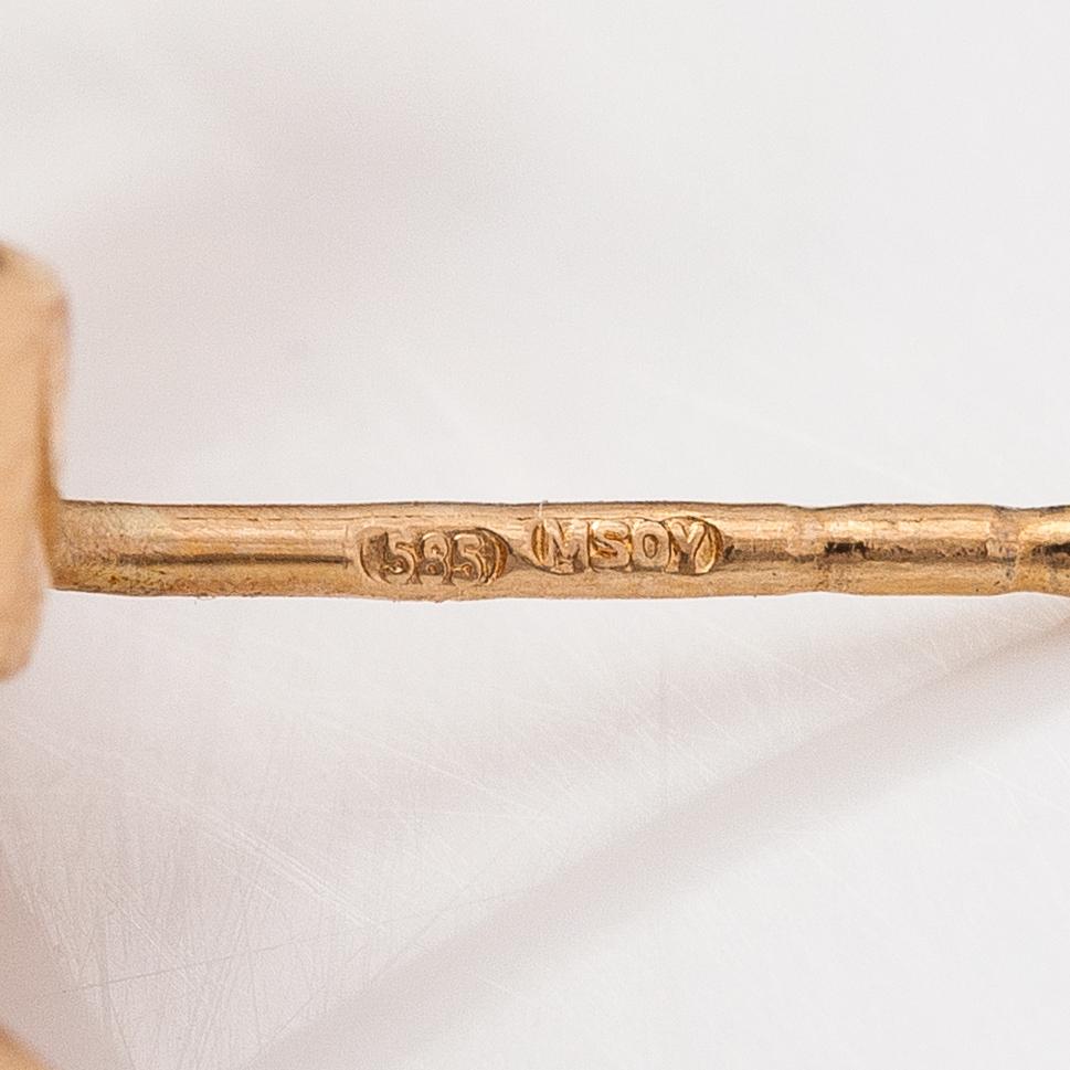 A pair of 14K gold earrings with diamonds ca 0.14 ct in total.