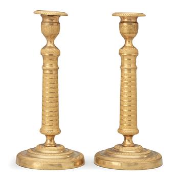 770. A pair of French Empire early 19th century candlesticks.