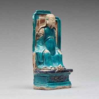 A turquoise and purple glazed figure of a dignitary, Qing dynasty, Kangxi (1662-1722).