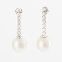 A pair of earrings in 18K white gold with cultured South Sea pearls and round brilliant-cut diamonds.