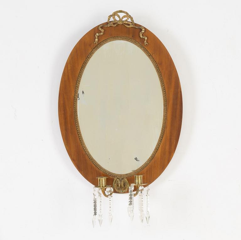 A mahogany veneered mirror sconce, Empire style, around 1900.
