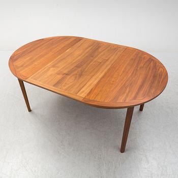 A second half of the 20th Century walnut veneered dinner table.