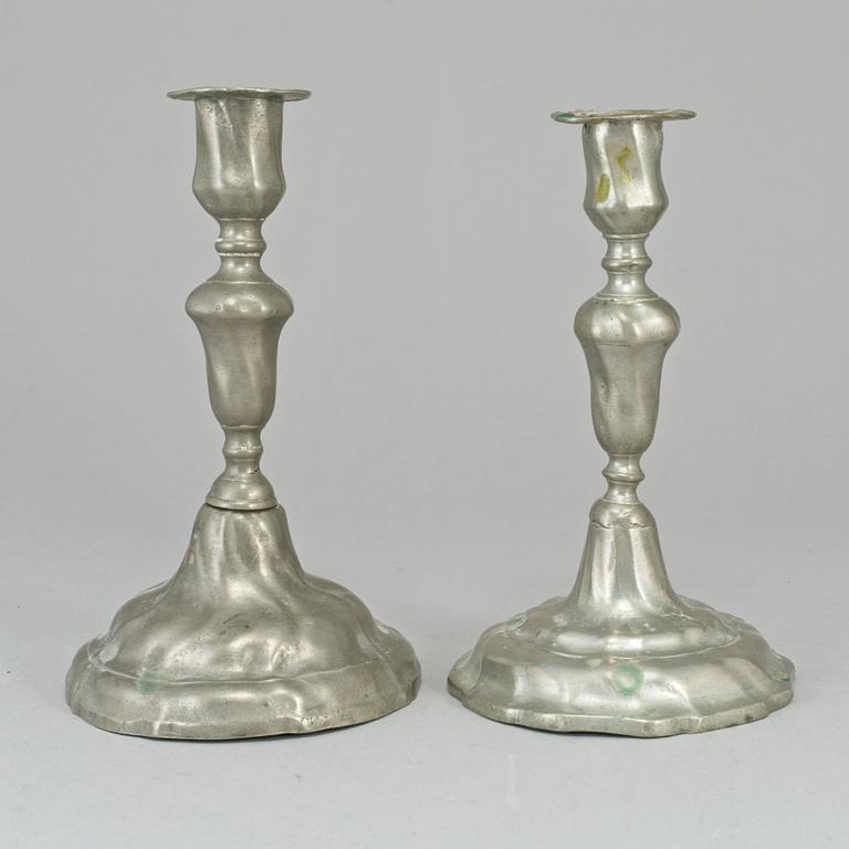 Two pewter rococo candlesticks.