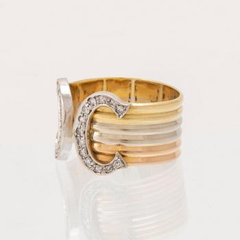 A Cartier "Double C" ring 18K tricolor gold set with round single-cut diamonds.