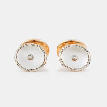 1253. A pair of mother of pearl and diamond cufflinks.