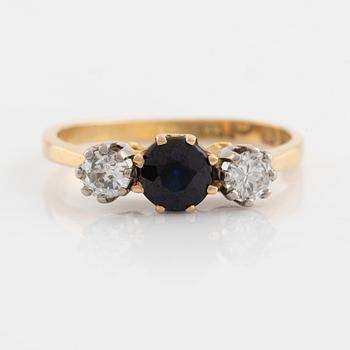 An 18K gold ring set with a sapphire and old-cut diamonds.