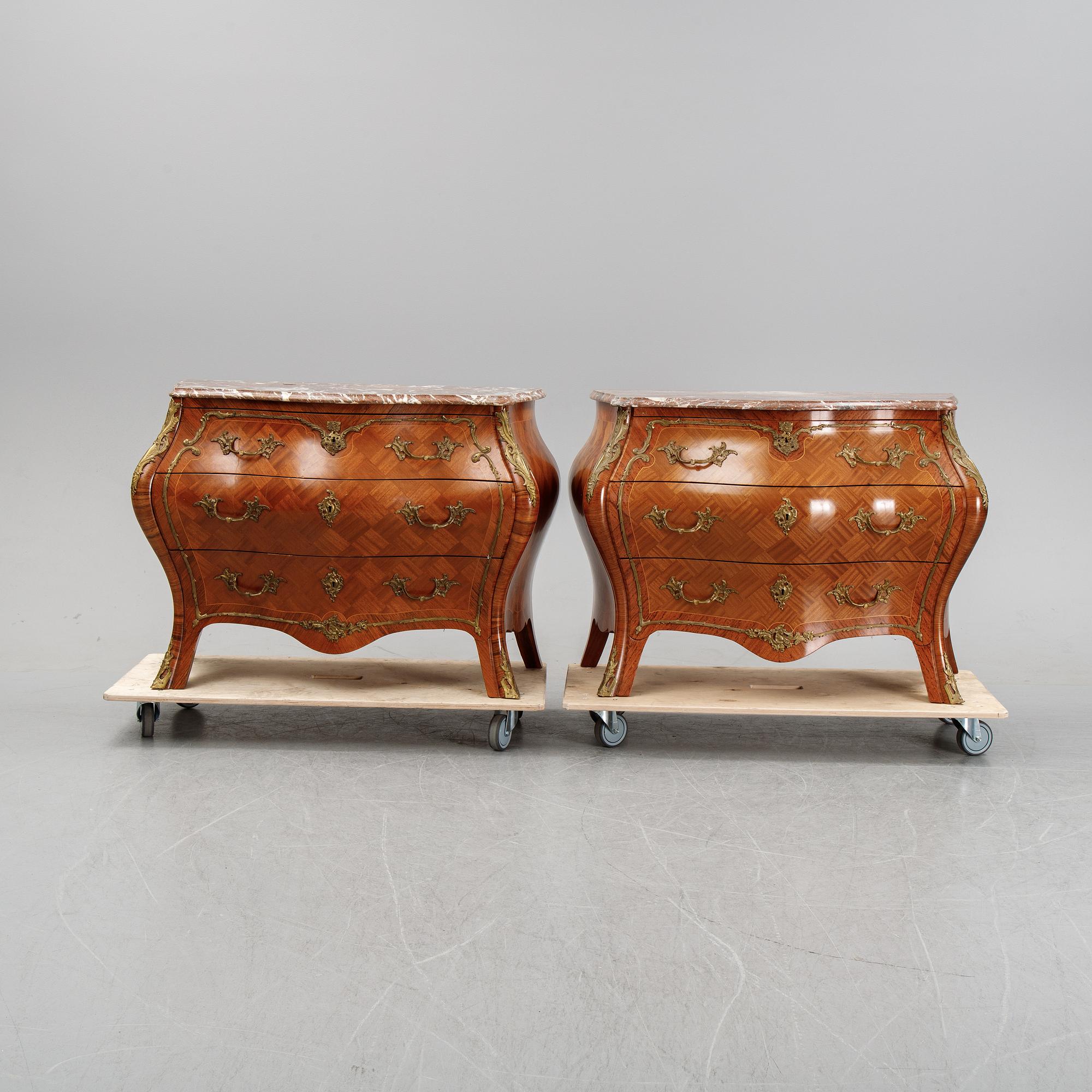 A pair of rococo style chest of drawers, mid 20th Century.