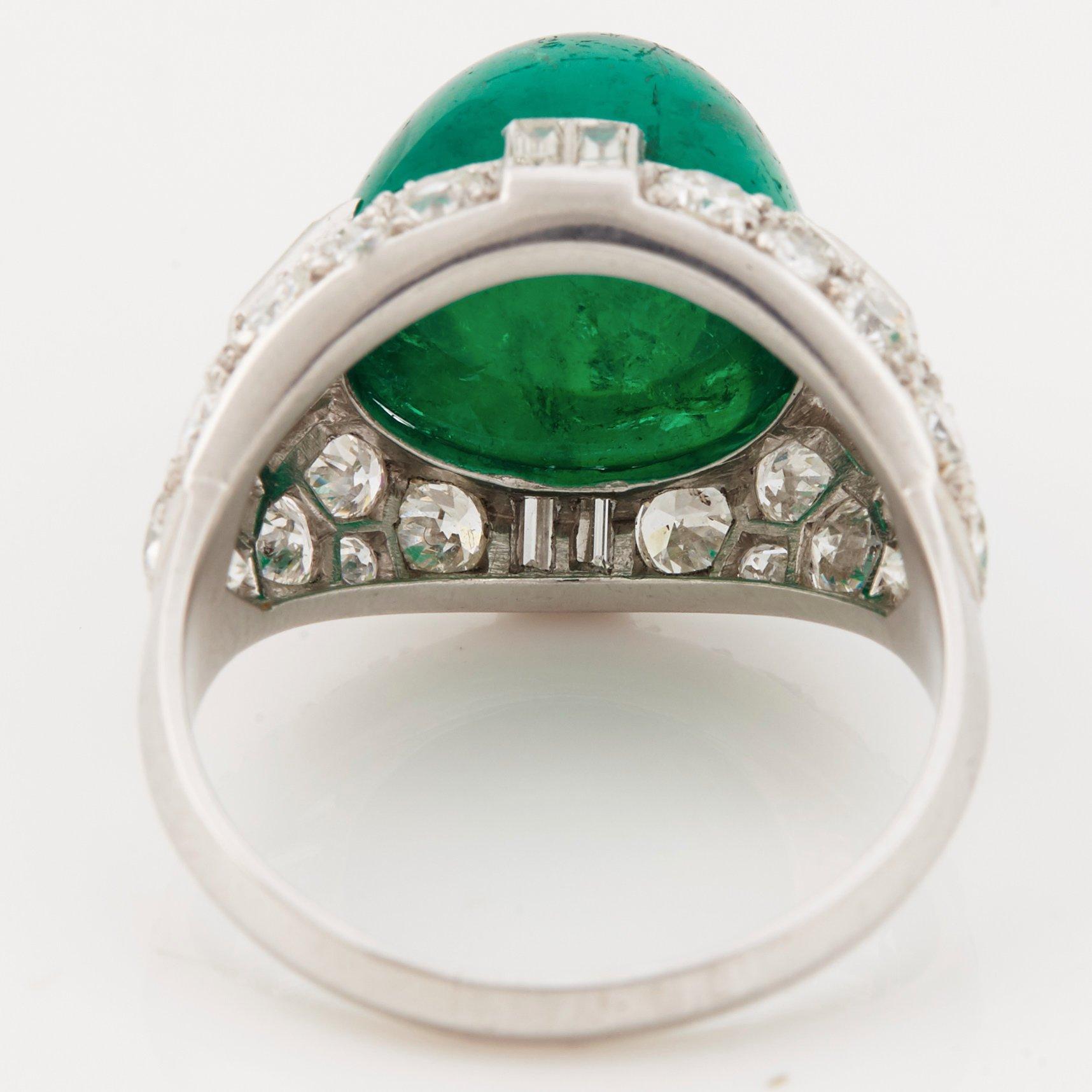 A cabochon-cut emerald, baguette, single and brilliant-cut diamond ring.