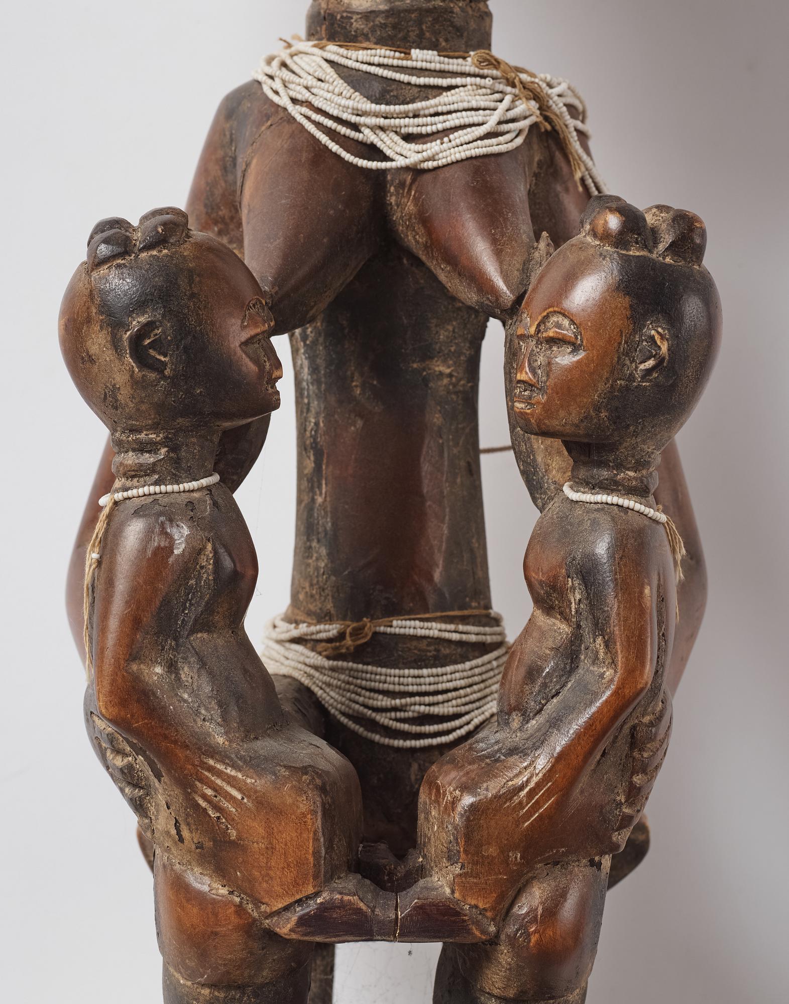 A sculptue and two masks reportedly from The Ivory coast, from the second half of the 20:th century.