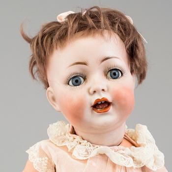 a porcelain doll from the early 20th century.