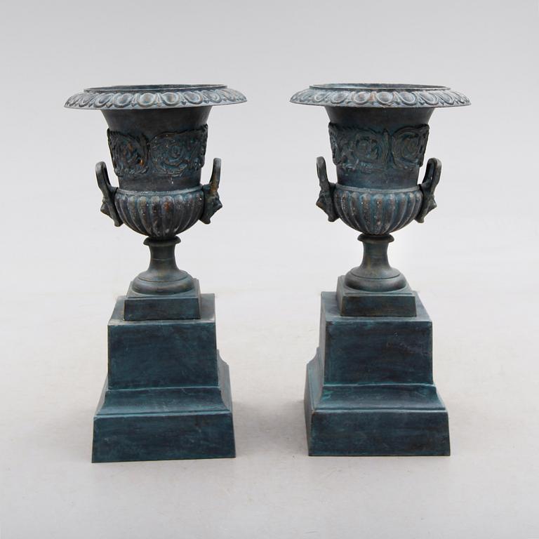 TRÄDGÅRDSURNOR PÅ PIEDESTALER, 1 par, gjutjärn, 1900-/2000-tal.
