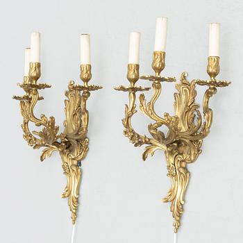 A pair of Rococo style wall lamps, early 20th Century.