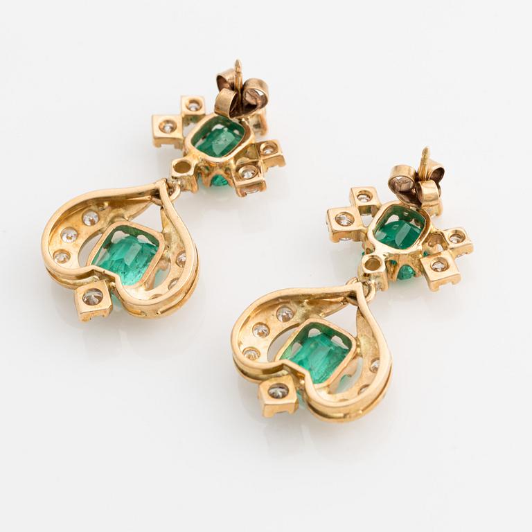 A pair of 18K gold earrings with faceted emeralds and round brilliant-cut diamonds.