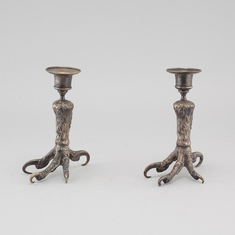 A pair of silvered metal candlesticks, around the year 1900.