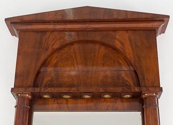 A first half of the 19th century mahogany veneered mirror.