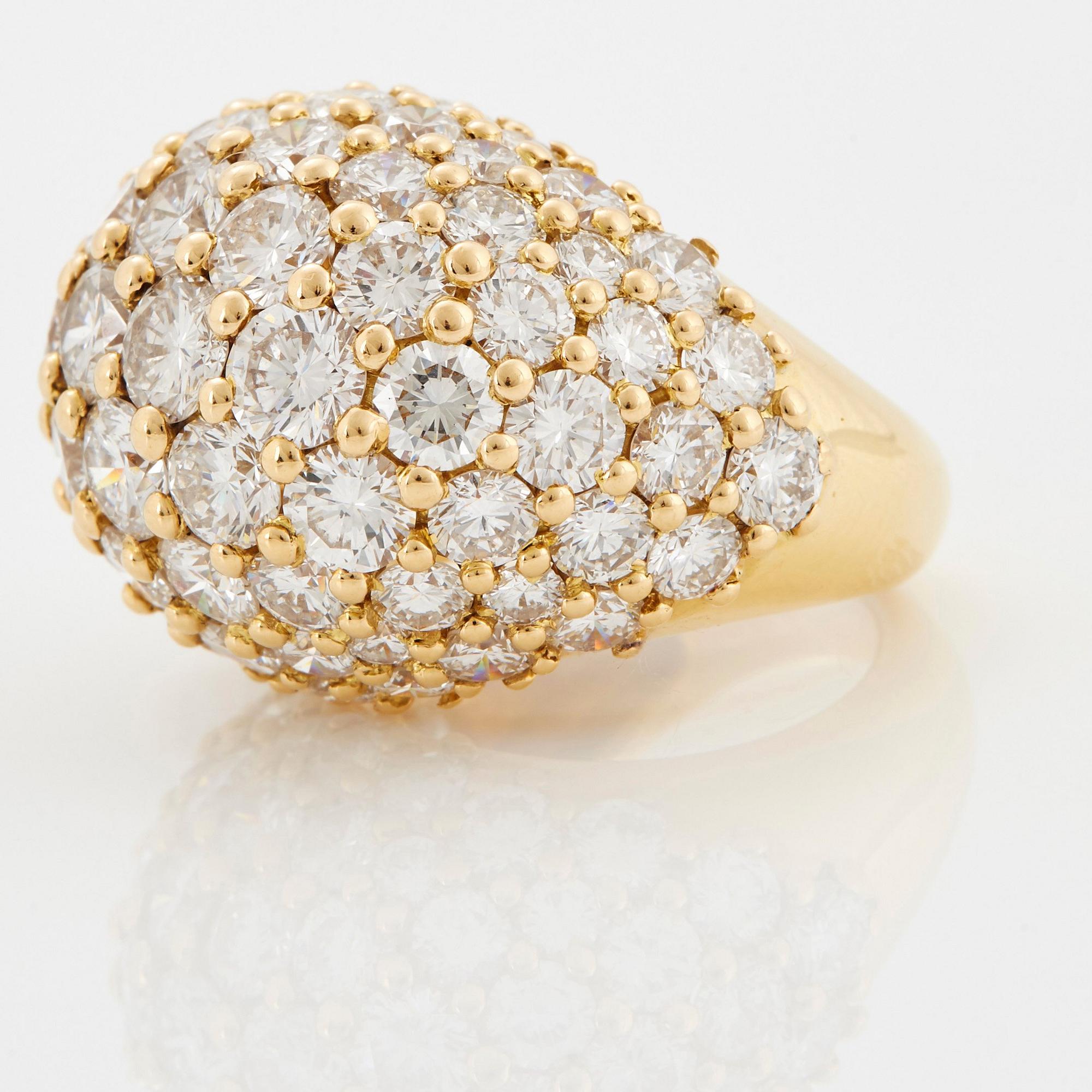 Cartier "Marrakech" an 18K gold bombé ring set with round brilliant-cut diamonds.