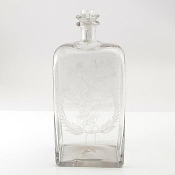 Brännvinsflaska, glas. Daterad Broby 1856.
