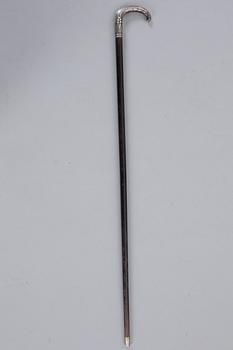 A CANE WITH SILVER MOUNTING, 1910.
