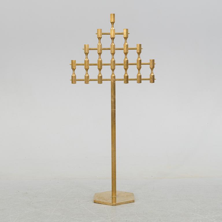 A brass floor candelabrum from Metallslöjden Gusum, signed BK and dated 1989.