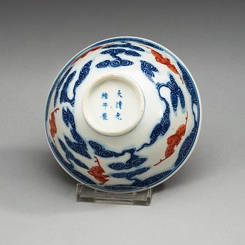 A blue and white bowl with bats in copper red, late Qing dynasty with Quangxu  six character mark.