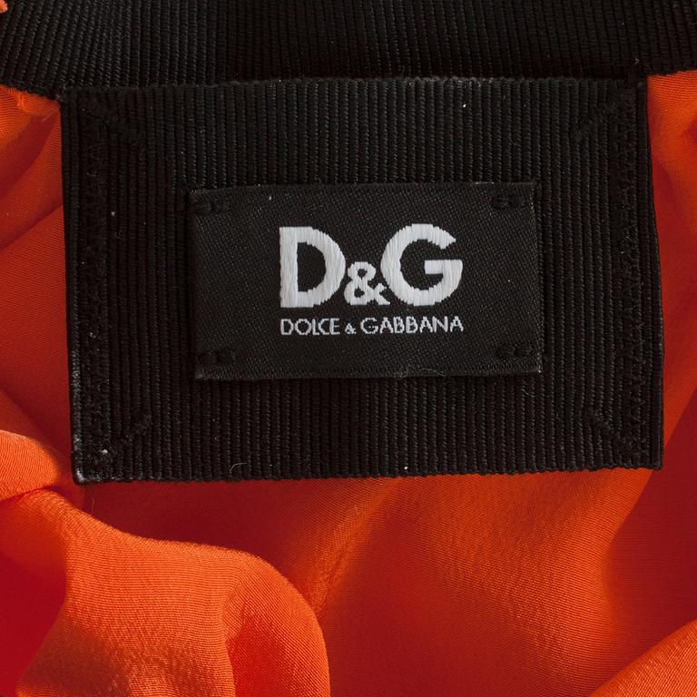 DOLCE & GABBANA, an orange silk cocktail dress.