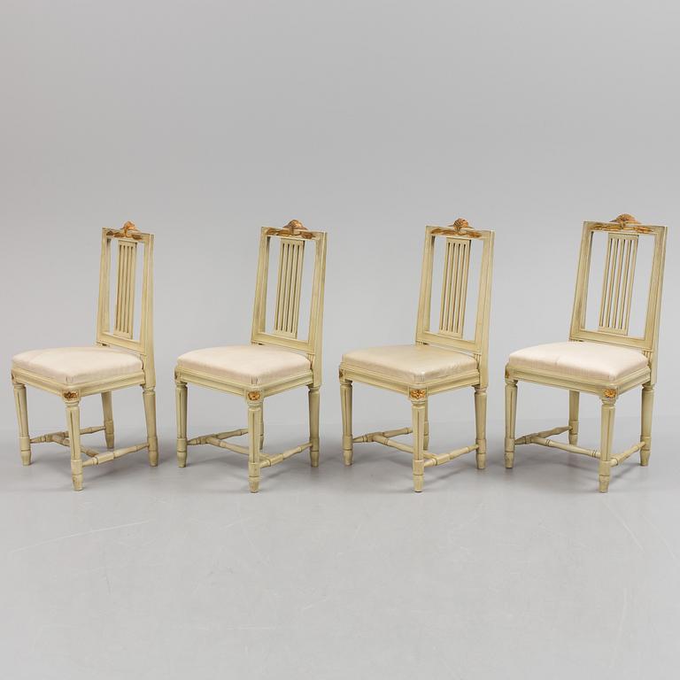 A lot of four mid 20th century Swedish Gustavian style chairs and one dinner table from around year 1900.
