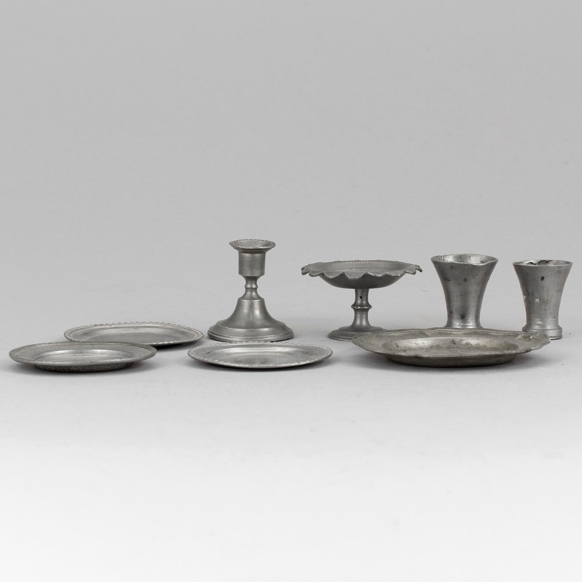 A lot of eight pewter doll house accessories 19th century.