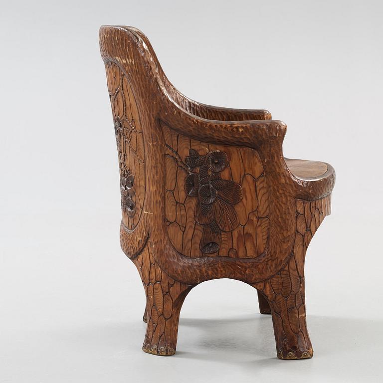 A Gustaf Fjaestad Art Nouveau carved pine chair, 'Stabbestol', by Adolf Swanson, Arvika, Sweden 1908.