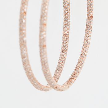 Rose gold and diamond hoop earrings.