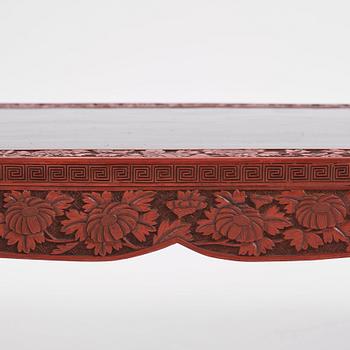 A carved lacquered table, early 20th Century.