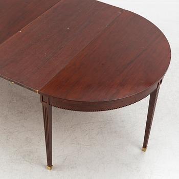 An Empire style dining table and ten chairs, second half of the 20th Century.