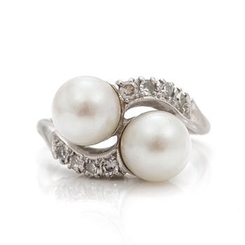 A cross-over ring of two cultured pearls with eight-cut diamonds.