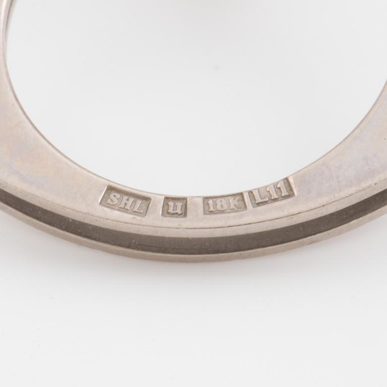 A ring set with a cultured pearl and a synthetic ruby.