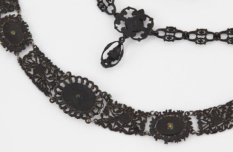 A Berlin steel and iron parure comprising a necklace, two bracelets and a brooch.