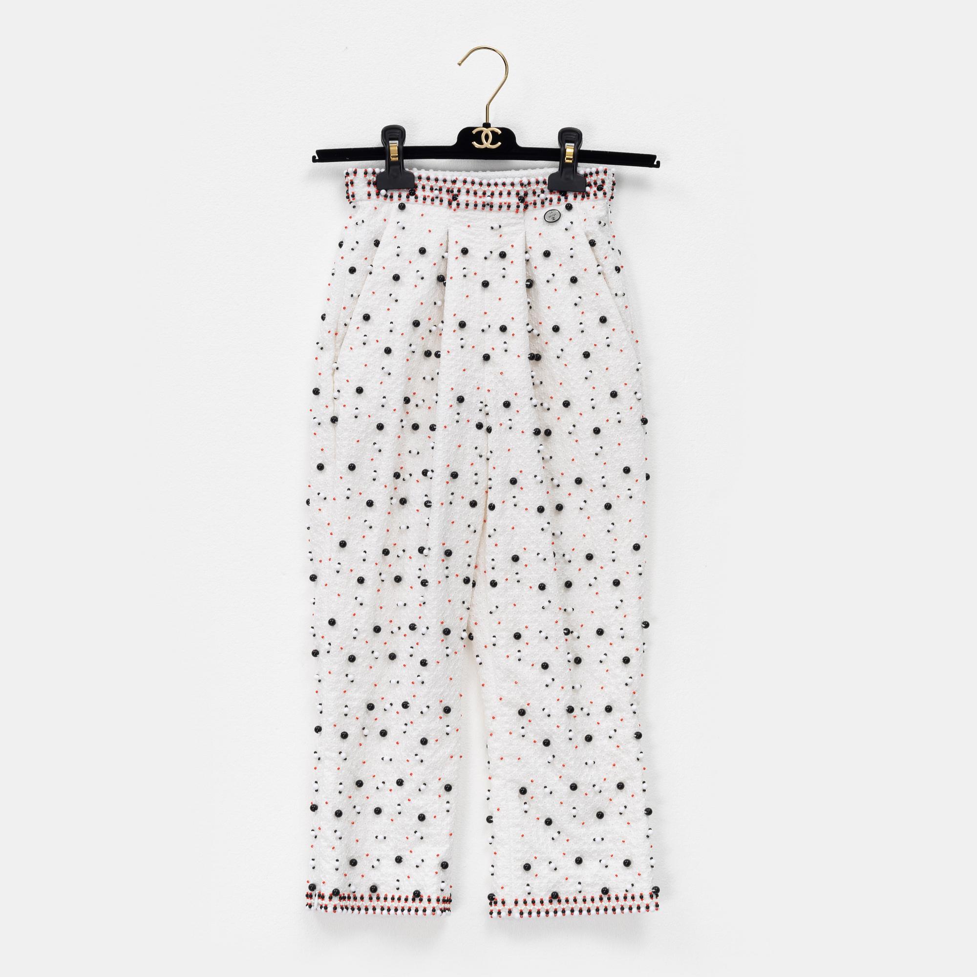 Chanel, a pair of broderie anglais trousers with pearls, size 34.