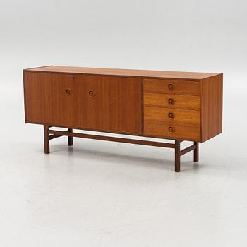 A 1960's teak-veneered sideboard.