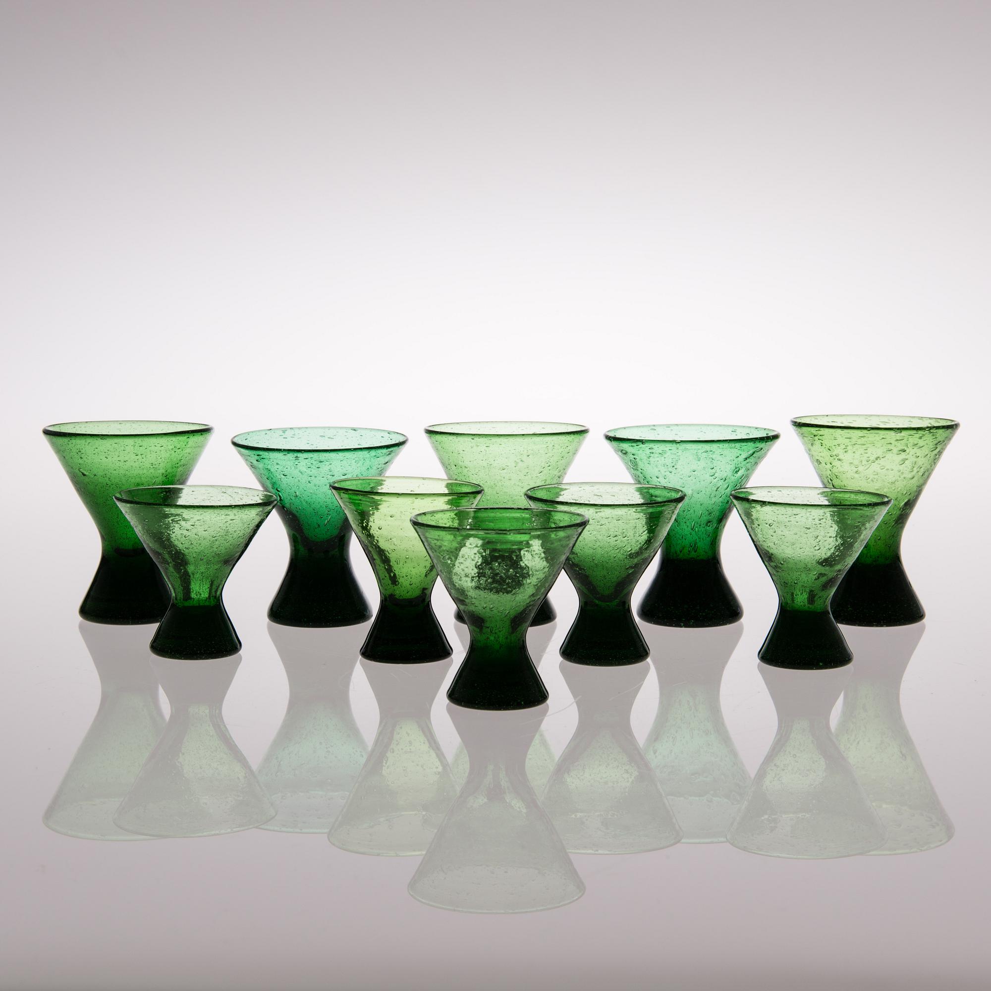 A set of ten "Vähän vino" (Slightly crooked) glasses, manufactured by Karhula in the 1930s.