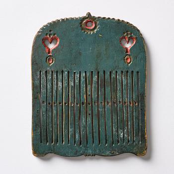 A Swedish folk art carved and polychrome-painted weaving tool from Hälsingland, late 18th/early 19th century.