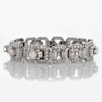 A platinum bracelet set with round brilliant- and eight-cut diamonds.