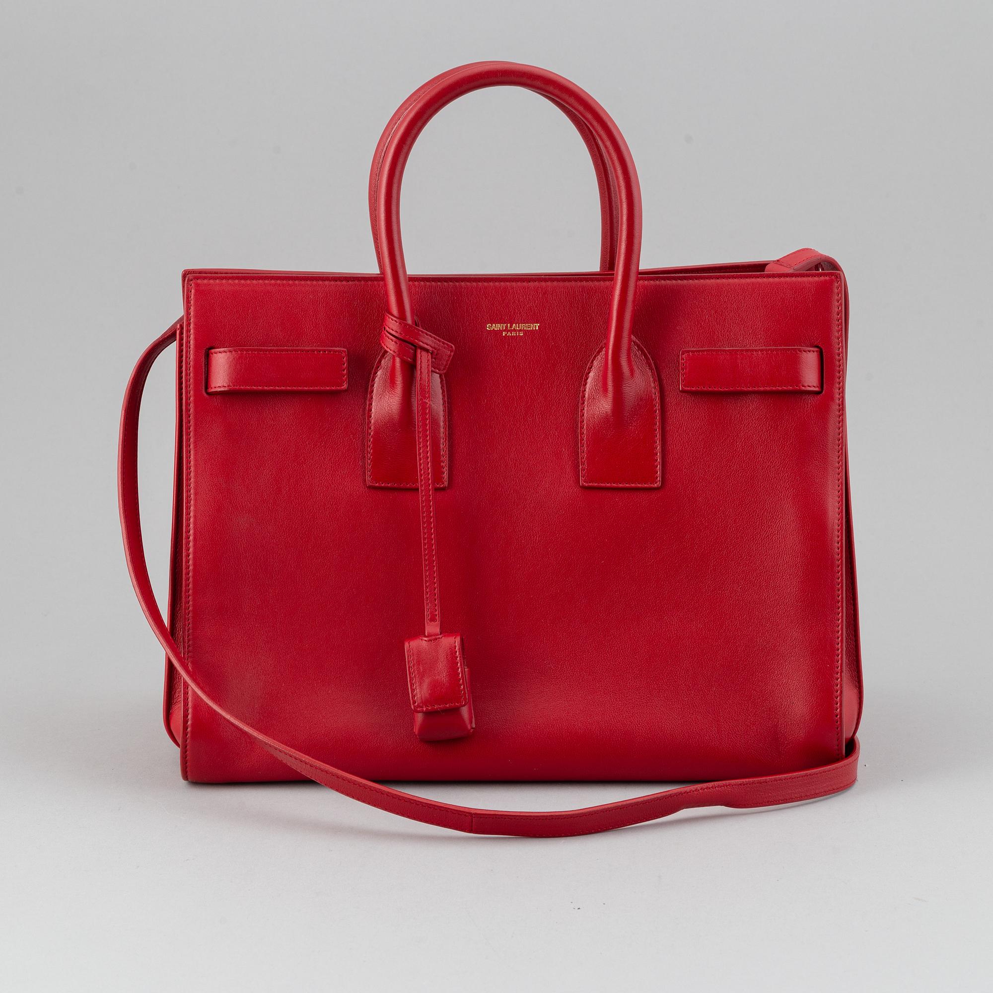 Saint Laurent, a red leather 'Sac du Jour Small' bag.