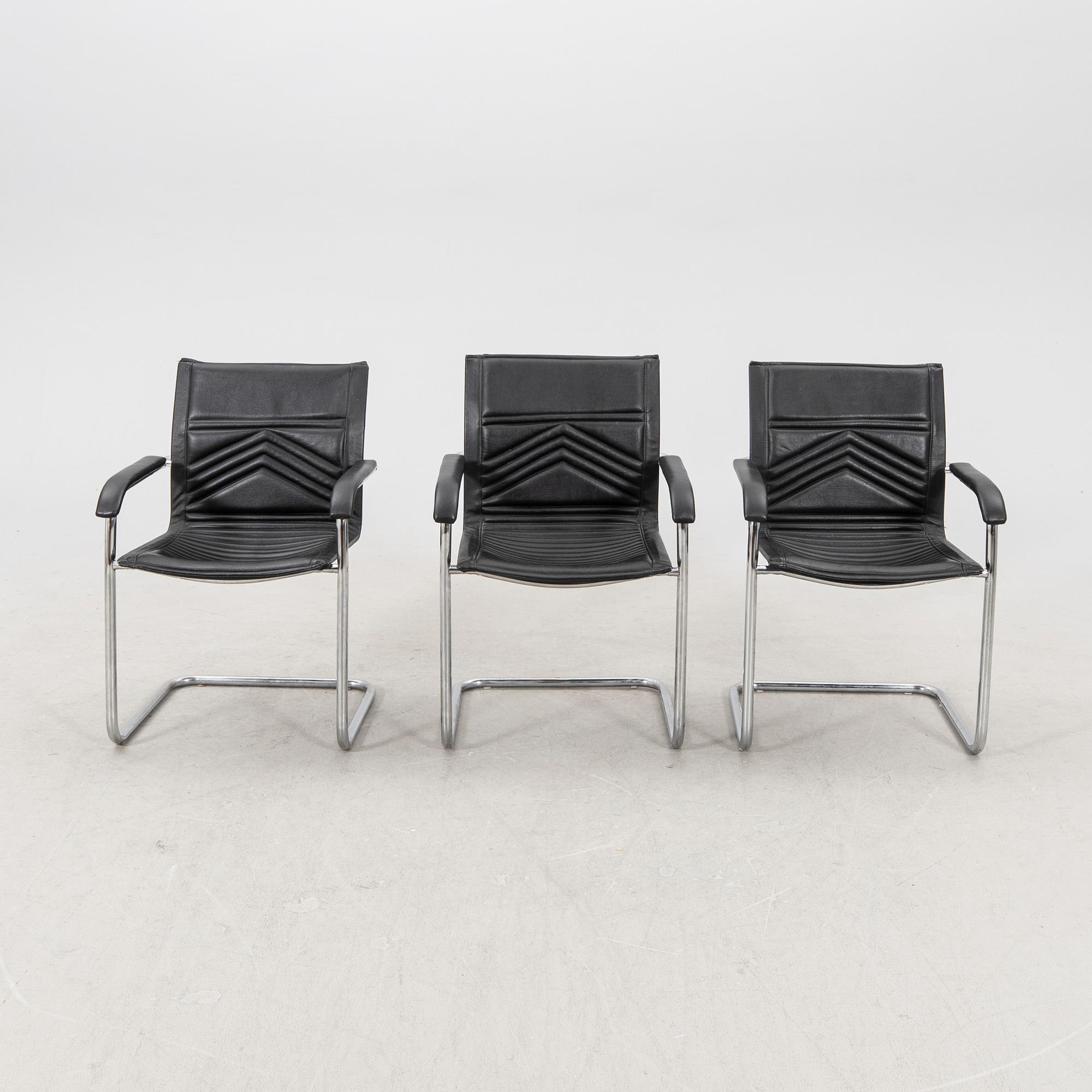 A set of five chrome and leather armchairs alter part of the 20th century.