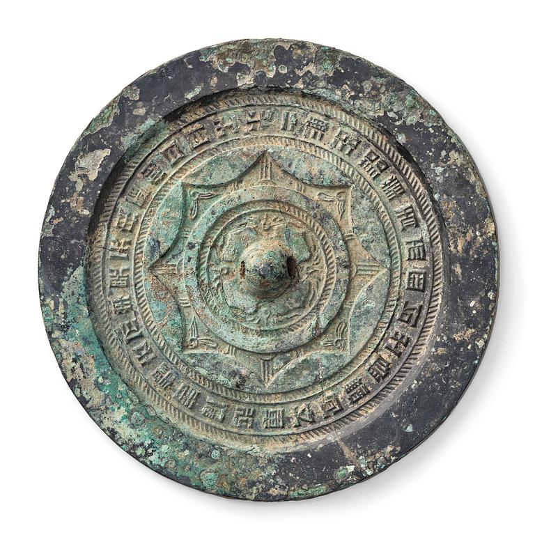 A circular bronze mirror, Han dynasty (206 B.C.-220 A.D.).