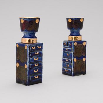 A pair of ceramic candlesticks signed Kaipiainen.