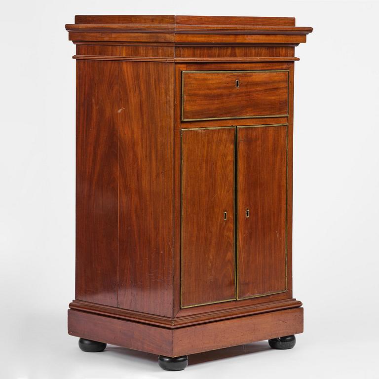 A late Gustavian mahogany column-cabinet, Stockholm, circa 1800.
