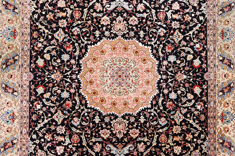 An old Tabriz carpet, c. 390 x 296 cm.