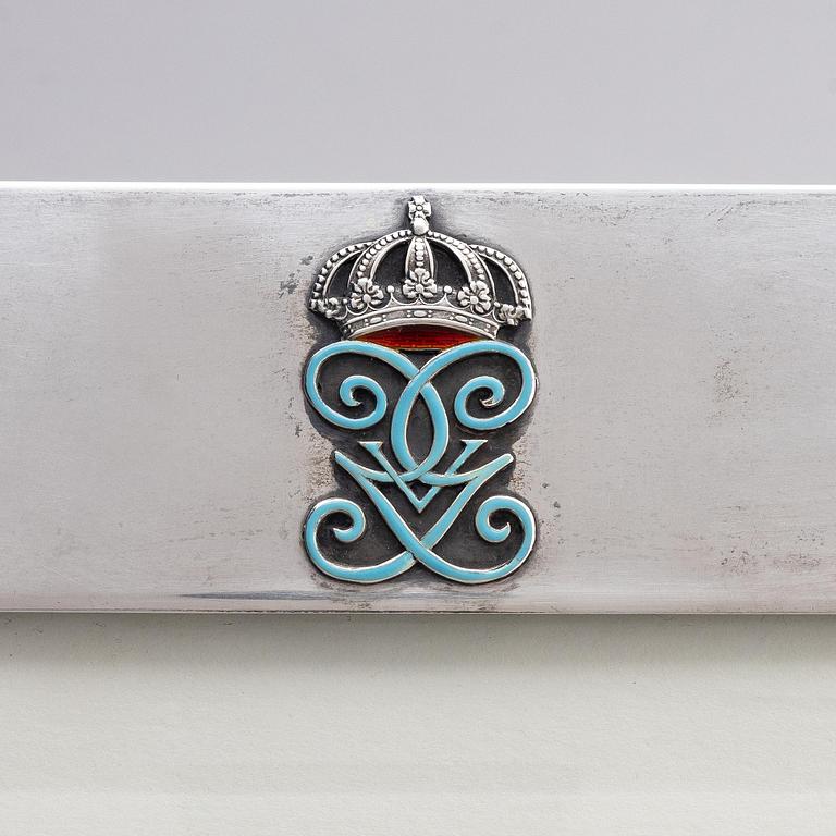A silver and enamel frame with glass, mark of CG Hallberg, Stockholm 1935.