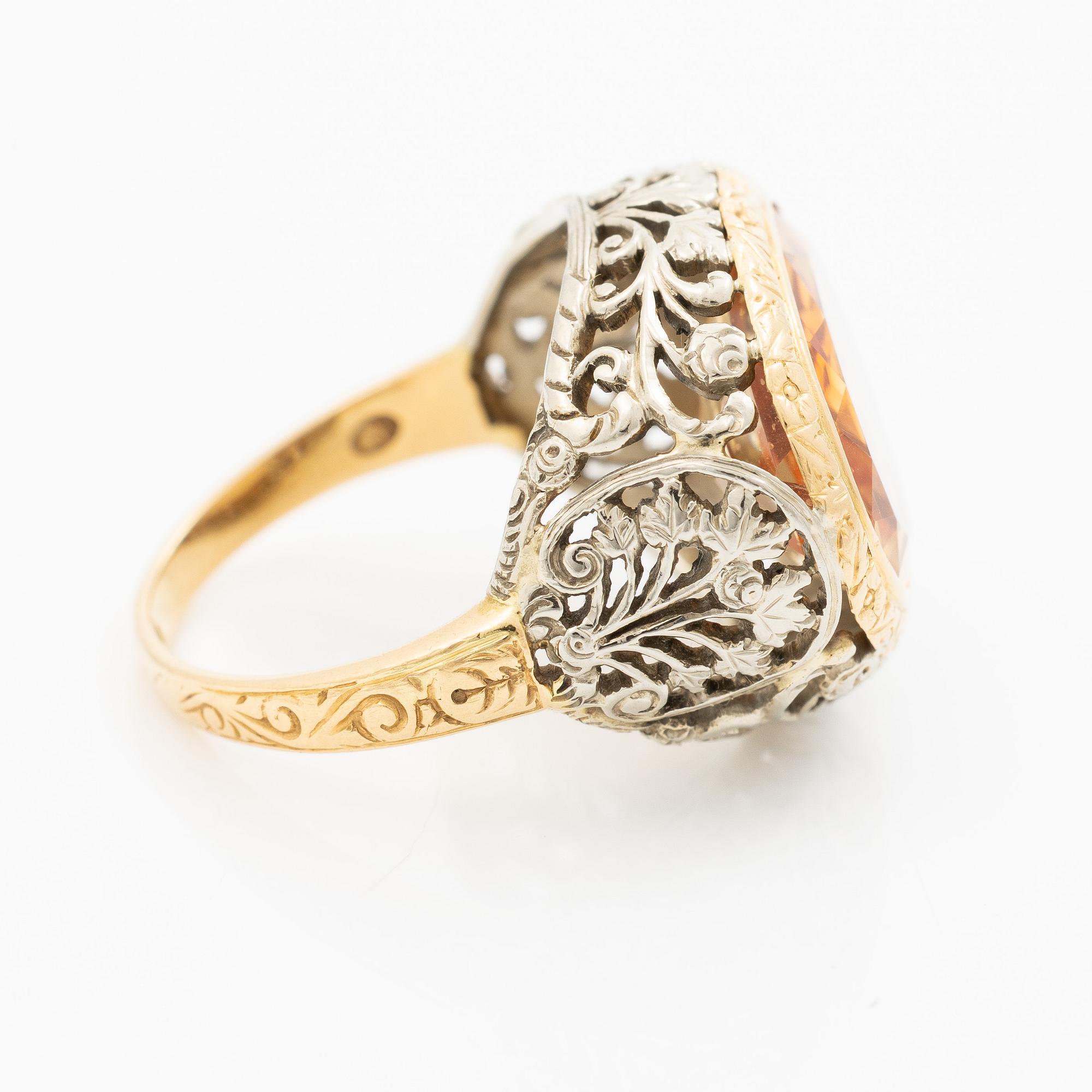 Gold ring with synthetic yellow sapphire.
