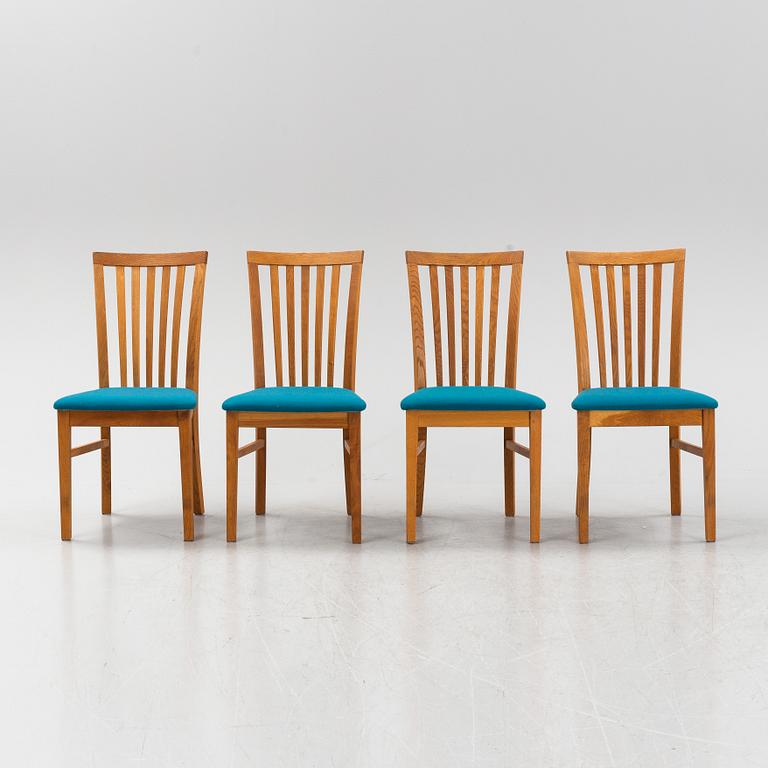 A set of four oak chairs from around the year 2000.
