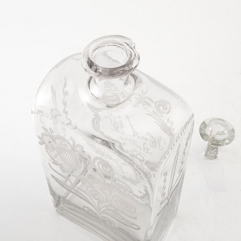 Brännvinsflaska, glas. Daterad Broby 1856.